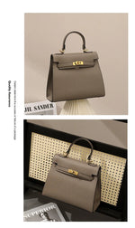 Brown handbag with gold hardware on a neutral background, featuring Jil Sander branding.