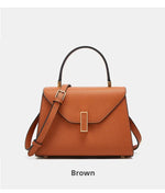 Brown handbag with gold buckle on a light gray background