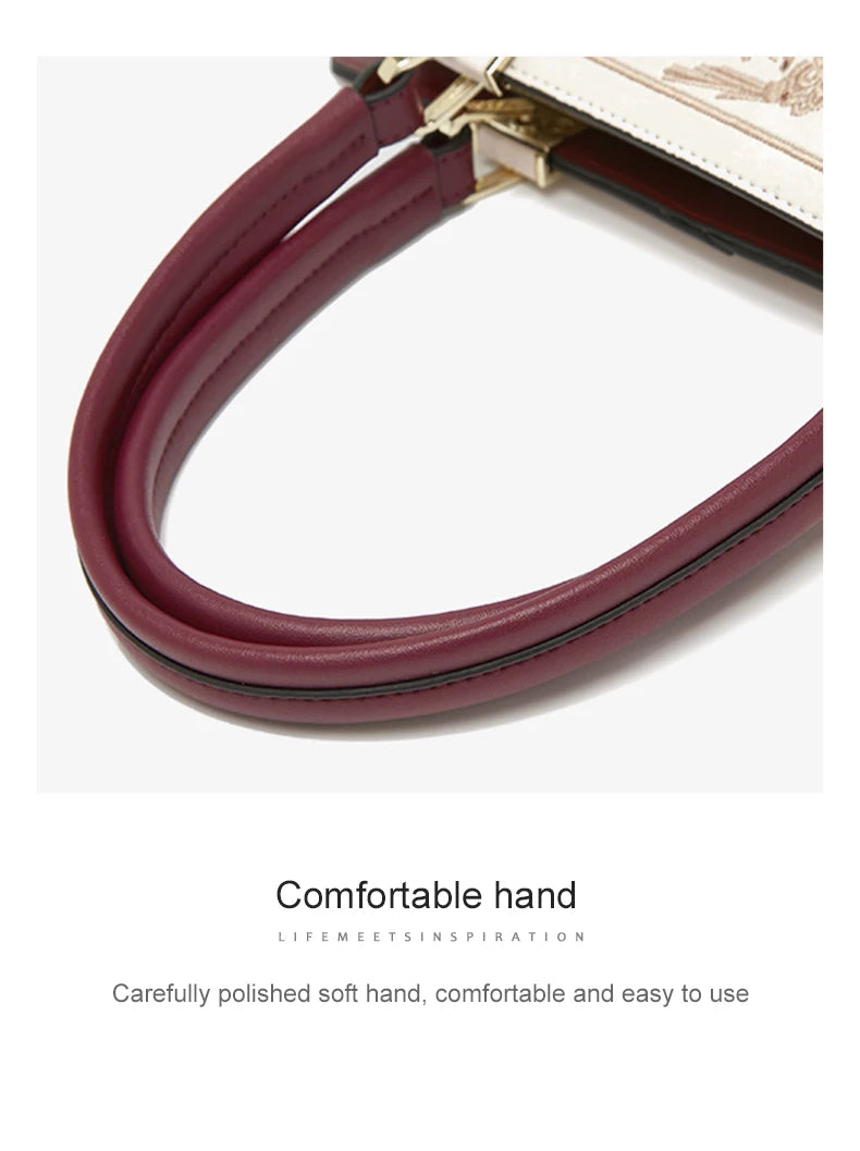 Close-up of a burgundy handbag strap with text on a white background