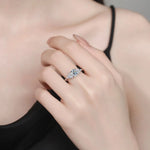 Close-up of a hand wearing a diamond ring with a blurred background