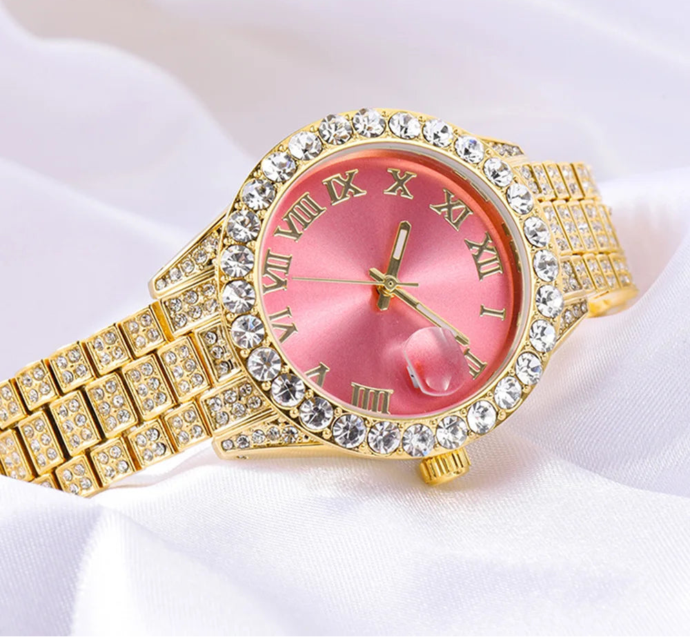 Gold watch with pink face and diamond accents on a white background