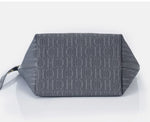 Gray clutch bag with a textured pattern on a light gray background