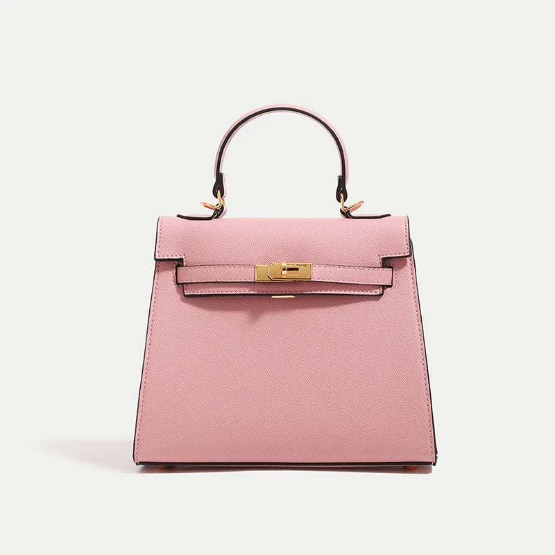 Pink handbag with gold hardware on a light gray background