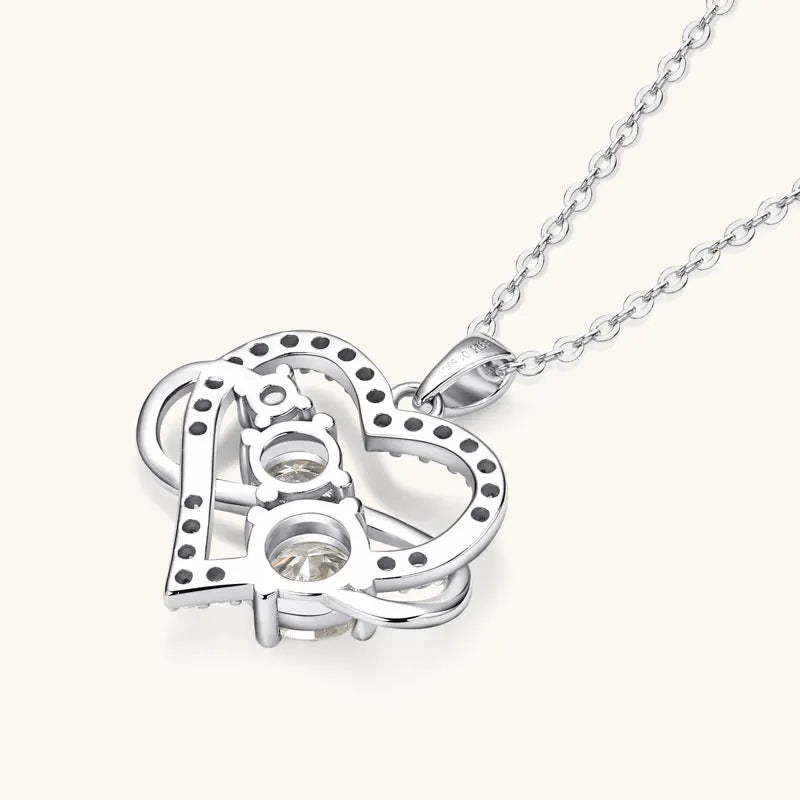 Silver heart-shaped pendant necklace on a white background