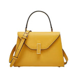 Yellow handbag with a strap on a white background