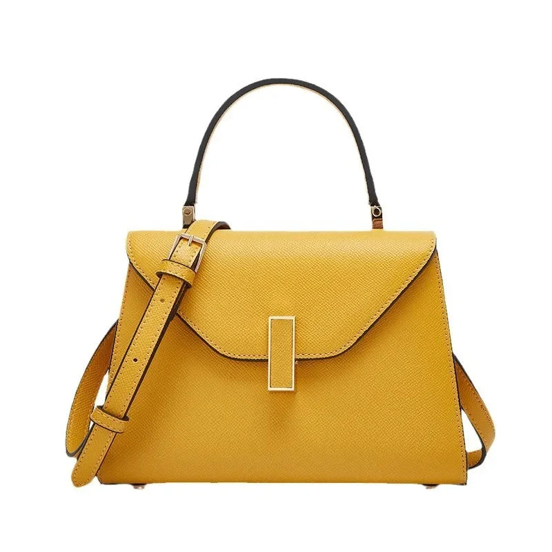 Yellow handbag with a strap on a white background