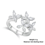 Silver ring with floral design and '925 Sterling Silver' marking on a white background