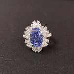 Diamond ring with a blue gemstone on a black background