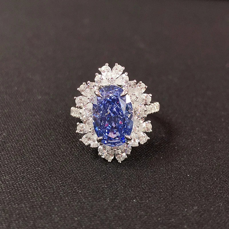 Diamond ring with a blue gemstone on a black background
