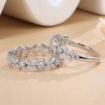 Silver bracelet with diamond-like stones on a beige surface