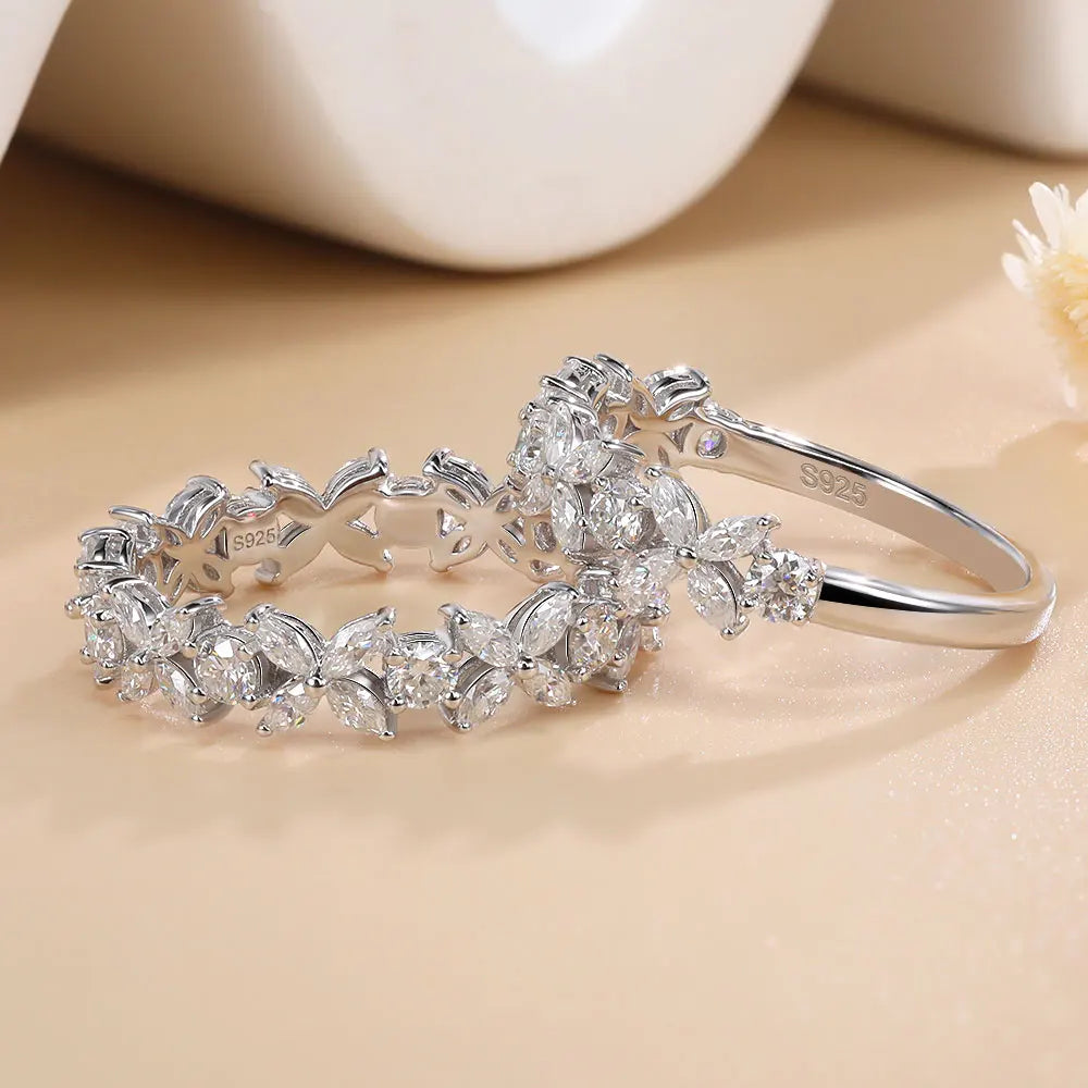 Silver bracelet with diamond-like stones on a beige surface