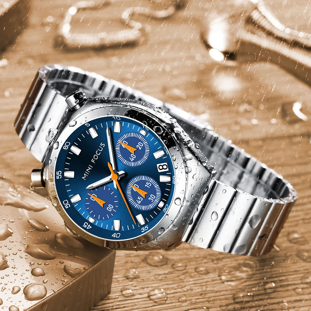 Silver watch with a blue face on a wet wooden surface