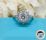 Silver ring with a large diamond on a blue surface, featuring the brand 'Joyce Jelly'.