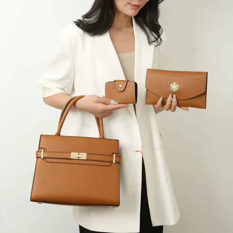 Woman holding two brown handbags against a plain background