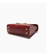 Red handbag with gold accents on a white background