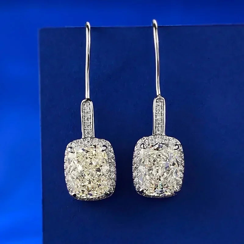 Pair of diamond earrings on a blue background