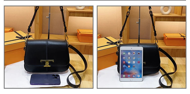 Black handbag with a phone and tablet on a white surface, with a wooden cabinet in the background.