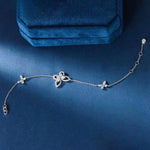 Silver bracelet with floral designs on a blue background
