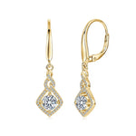 Gold earrings with clear gemstones on a white background