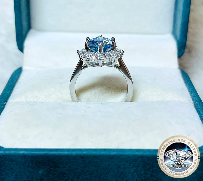 Silver ring with blue gemstone in a jewelry box, featuring 'Joyeux Jelly' branding.