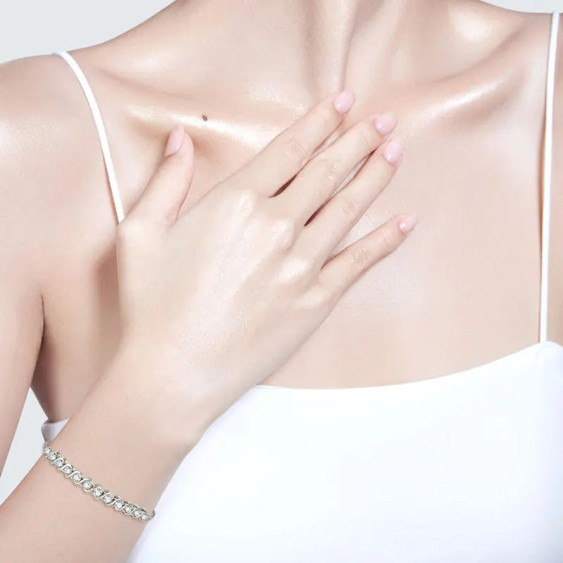 Partial view of a person wearing a white bralette with a focus on the chest area.