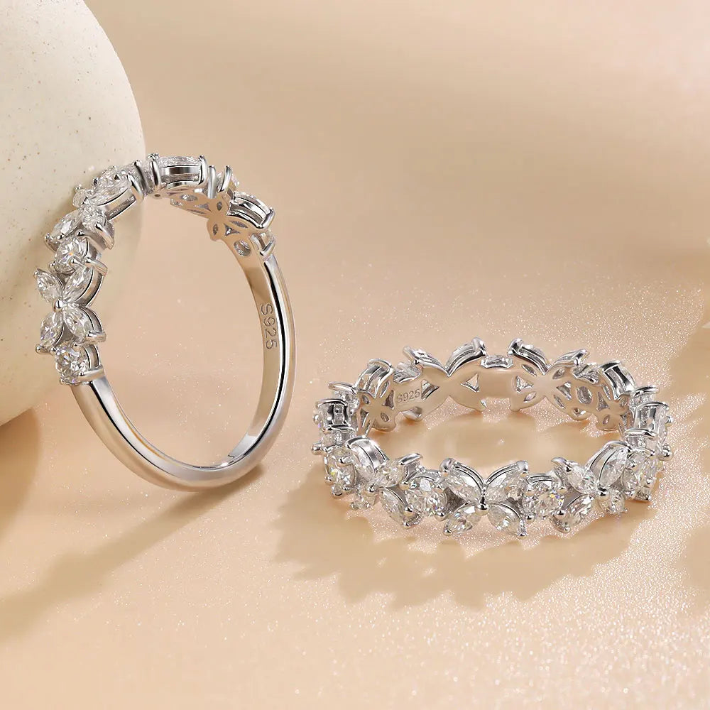 Two silver hoop earrings on a beige background