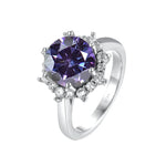 Silver ring with a purple gemstone on a white background