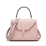 Pink handbag with black handle on a white background