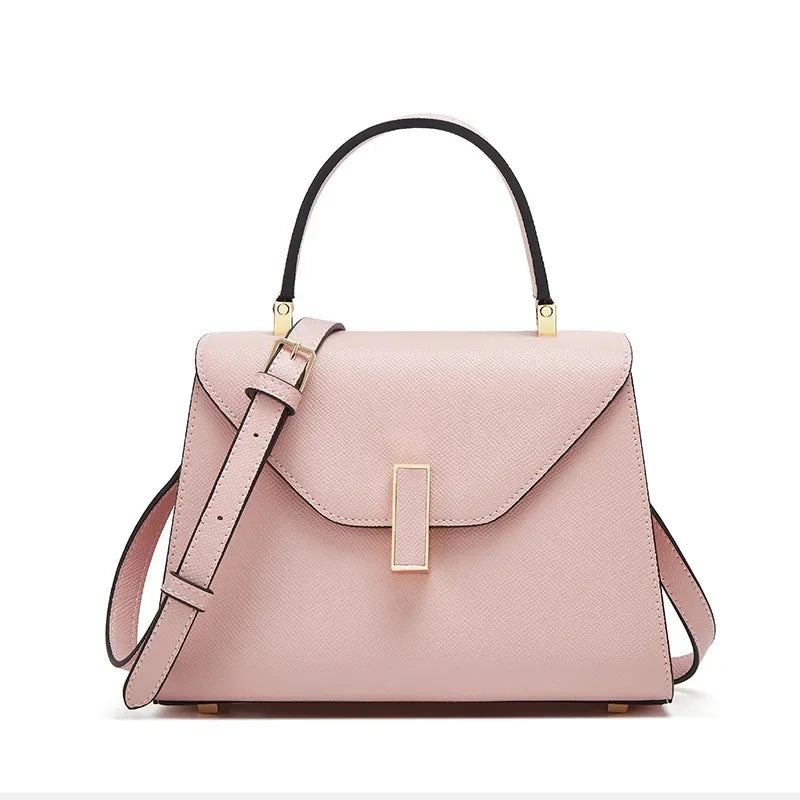 Pink handbag with black handle on a white background