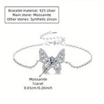 Silver bracelet with butterfly design and gemstones on a white background