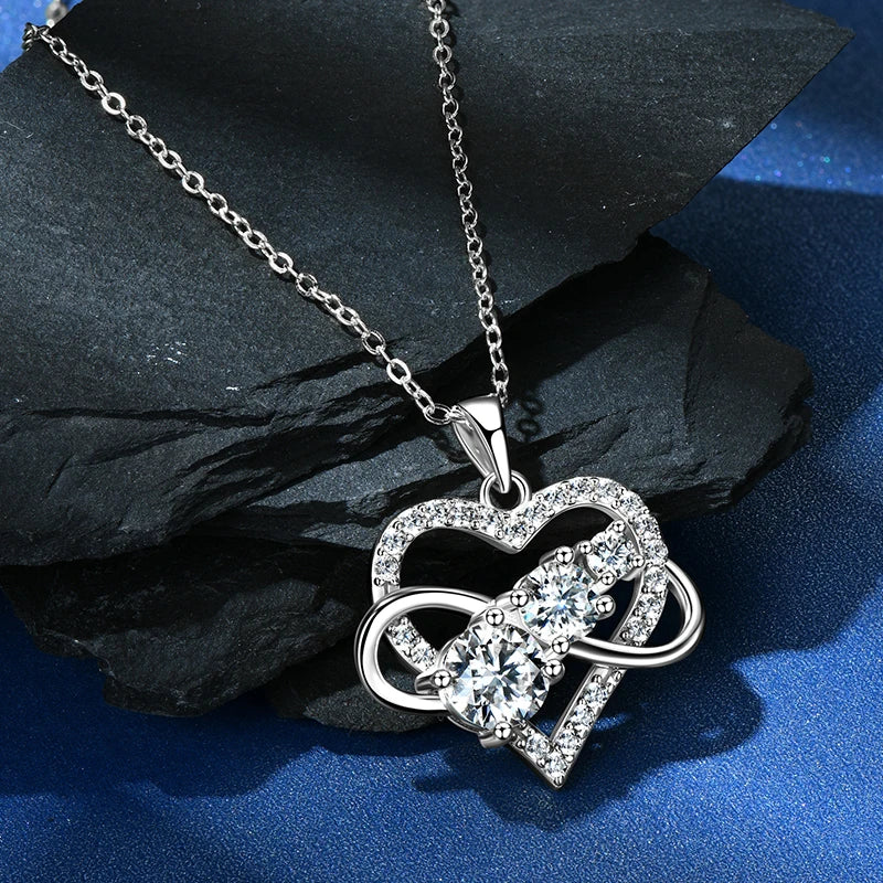 Silver heart-shaped pendant necklace on a dark surface
