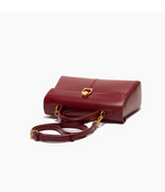 Red handbag with gold accents on a white background