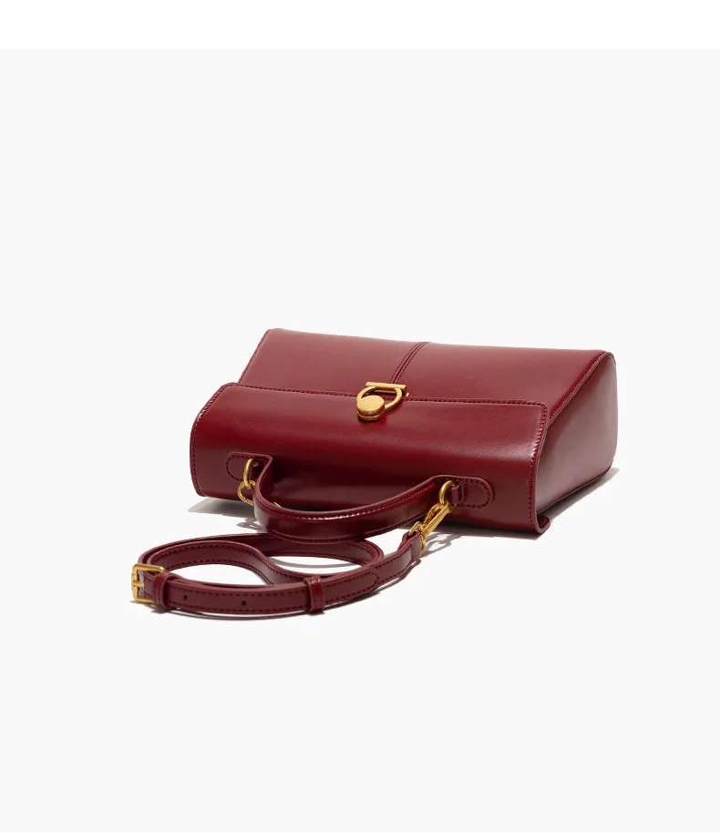 Red handbag with gold accents on a white background