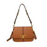 Brown leather handbag with gold accents on a white background