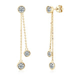Gold earrings with clear gemstones on a white background