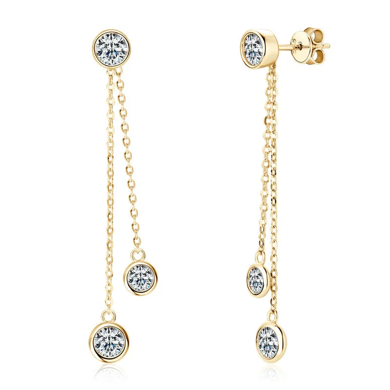 Gold earrings with clear gemstones on a white background