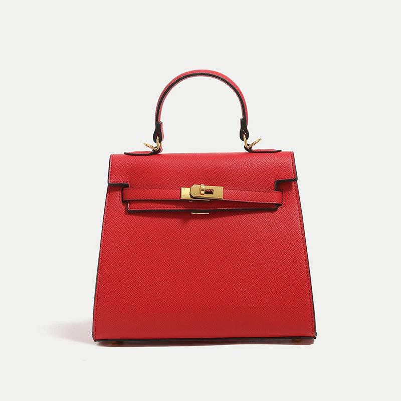 Red handbag with gold hardware on a light gray background