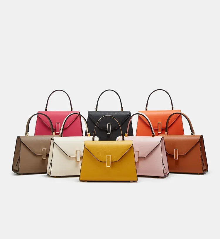 Set of eight handbags in various colors on a light gray background
