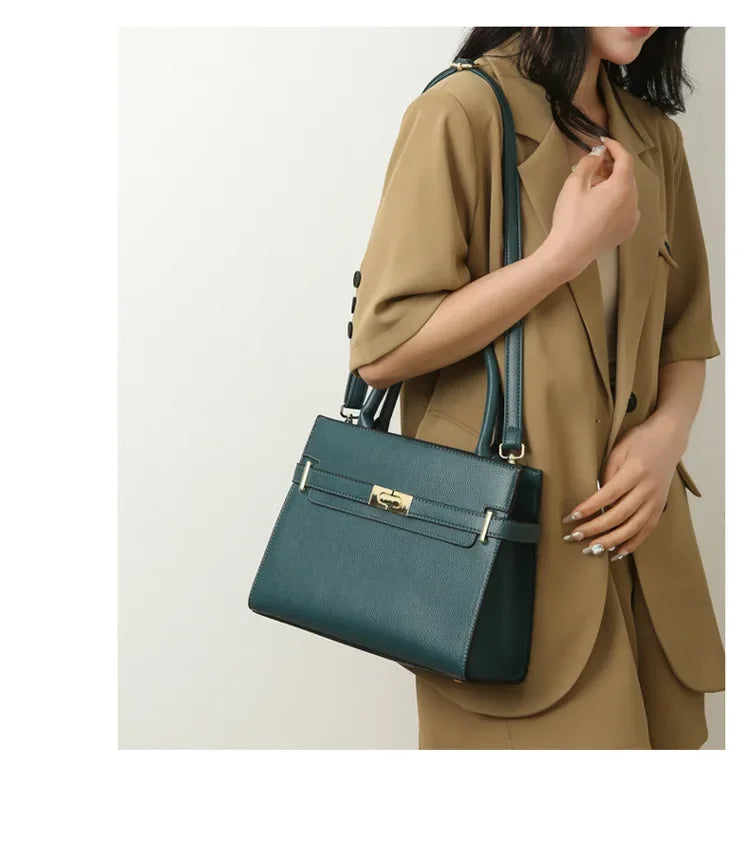 Person holding a teal handbag against a plain background