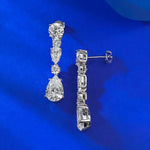 Pair of diamond earrings on a blue background