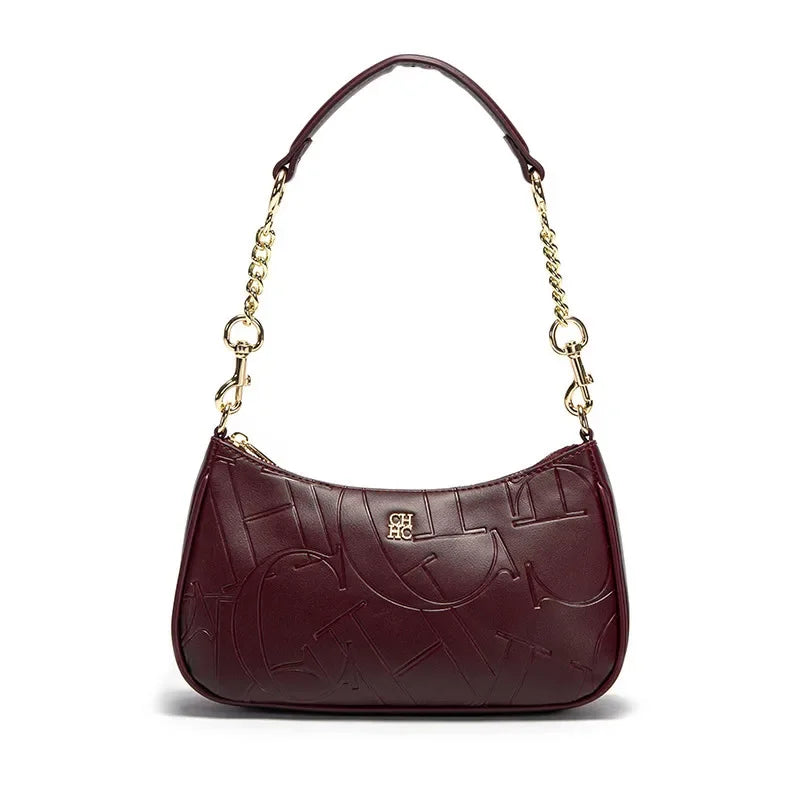 Brown handbag with gold chain strap on a white background