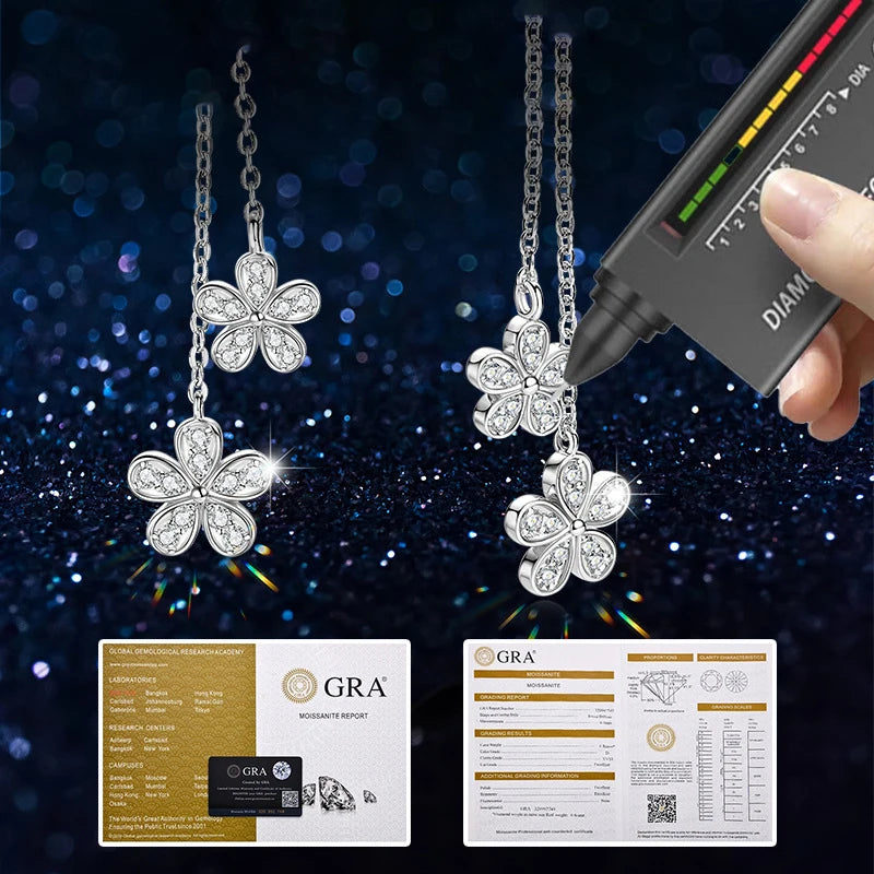 Silver flower-shaped necklace with diamond-like stones, held by a hand using a diamond检测器, with GRA certification cards displayed.