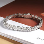 Silver bracelet with clear stones on a white surface