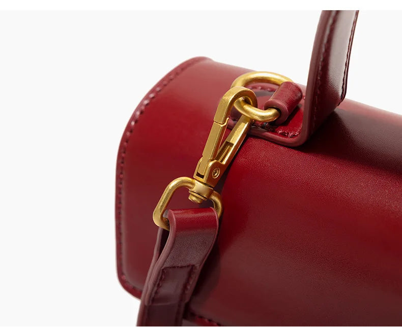 Red handbag with gold hardware on a white background