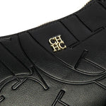 Close-up of a black leather product with gold logo on a white background