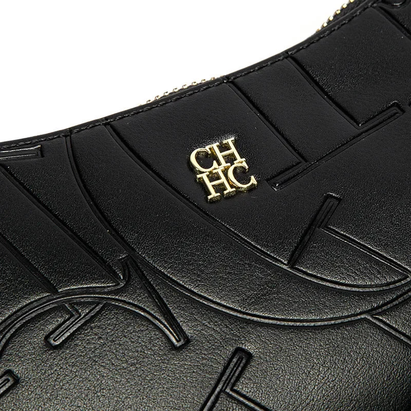 Close-up of a black leather product with gold logo on a white background