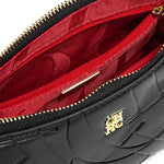 Black handbag with red interior and gold zipper, featuring a brand logo.