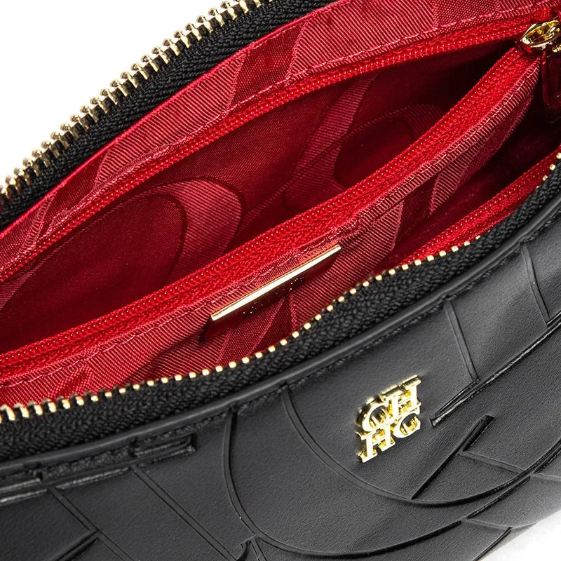 Black handbag with red interior and gold zipper, featuring a brand logo.
