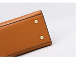 Brown leather wallet with gold accents on a white background