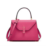 Pink handbag with a gold clasp on a white background